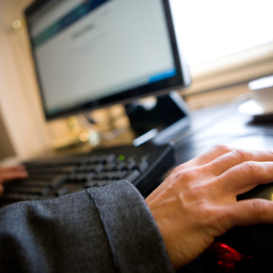 man on computer at desk