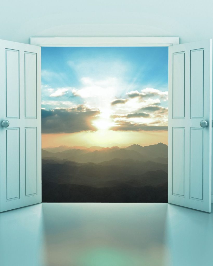 Open doors revealing a sunrise over distant mountains.