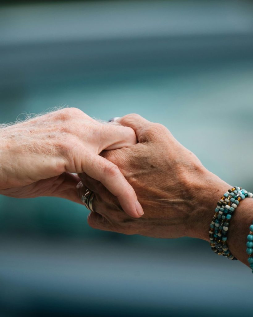 Two hands holding each other gently.