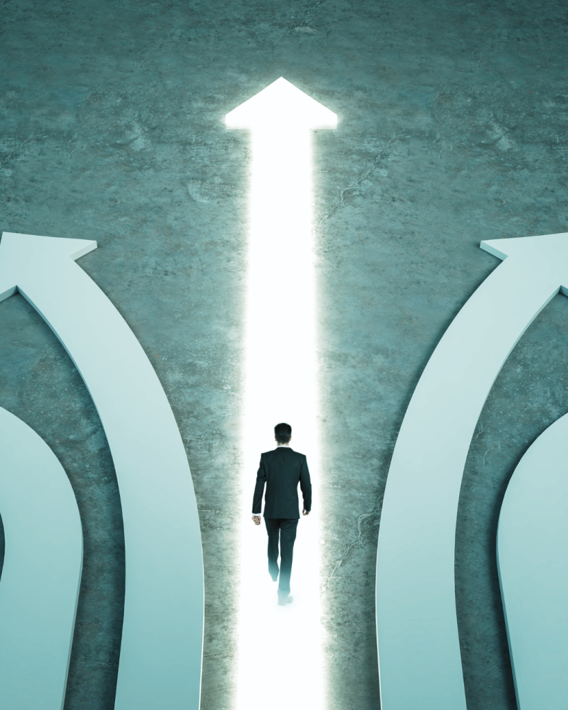 Silhouette of a person walking toward a bright pathway with arrows on either side, symbolising trust, safety and clear direction - reflecting Enhanced DBS safeguarding standards.