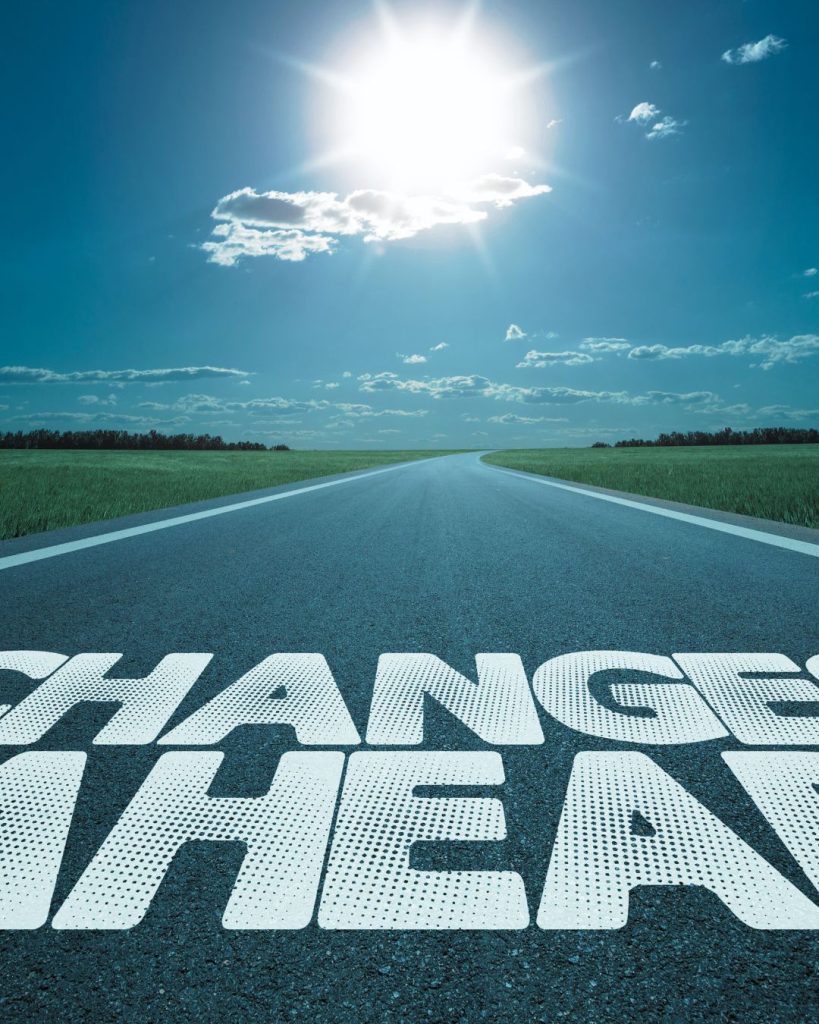 Road with words "Change ahead" written on the tarmac.