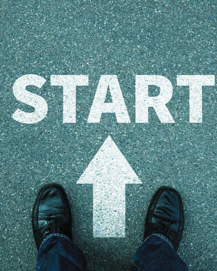 Feet standing in front of the word "start" with an arrow pointintg forward, symbolising taking the first step towards therapy